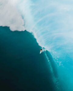 Capturing a surfer on a massive wave in Pupukea, Hawaii. Aerial shot epitomizing the thrill of surfing.